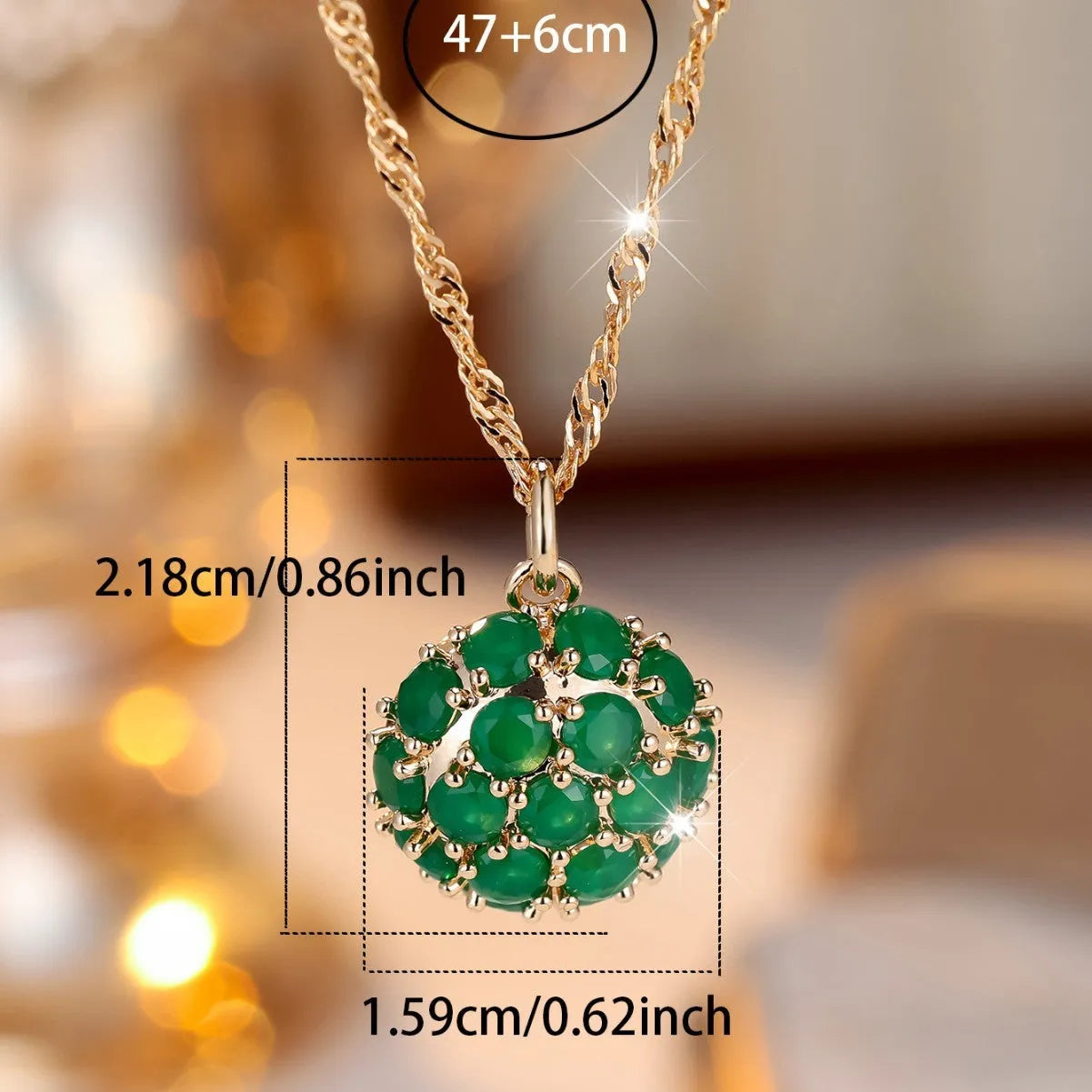Round emerald pendant necklace with diamond setting on champagne gold chain
