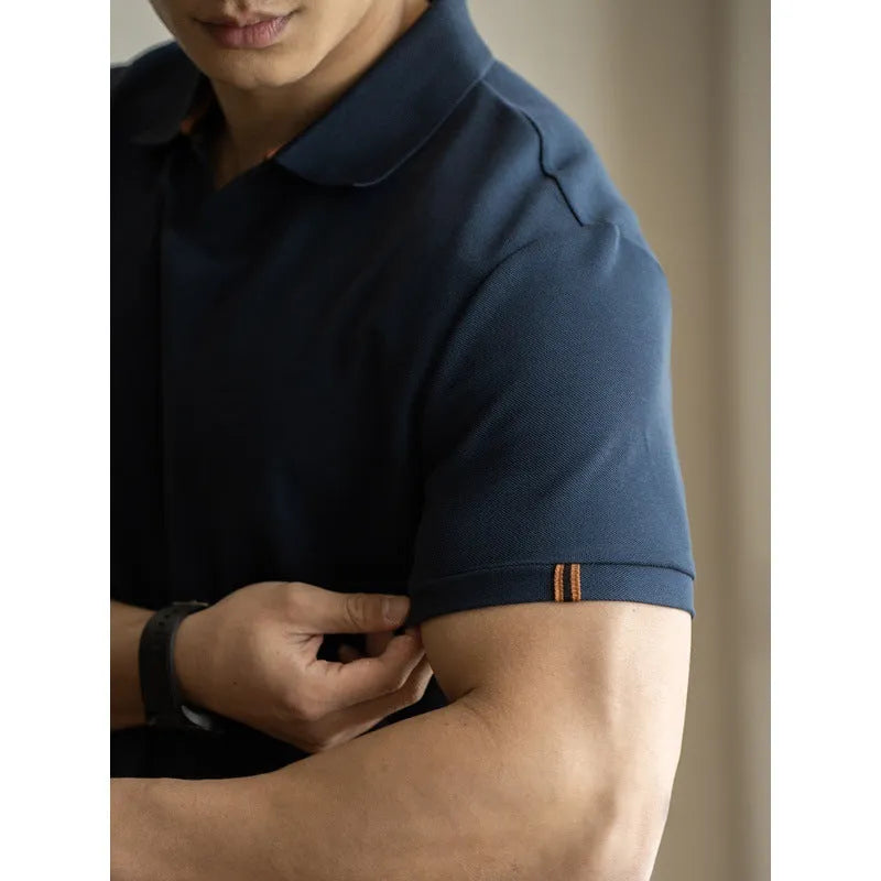 Man's short-sleeve blue polo shirt on a hanger, showing the classic collar and button placket.