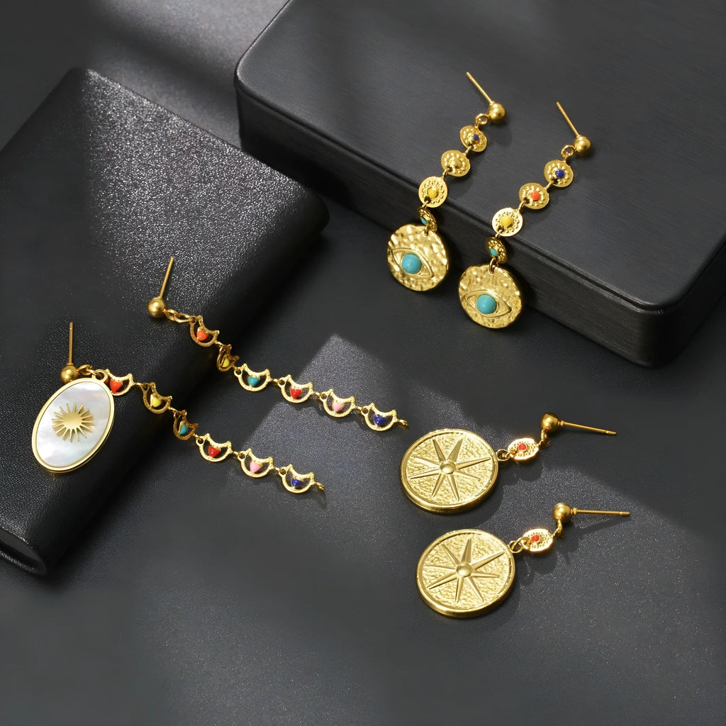 Stainless steel geometric earrings showing three style options: Eight Awn Star, Eye, and Shell Sun designs