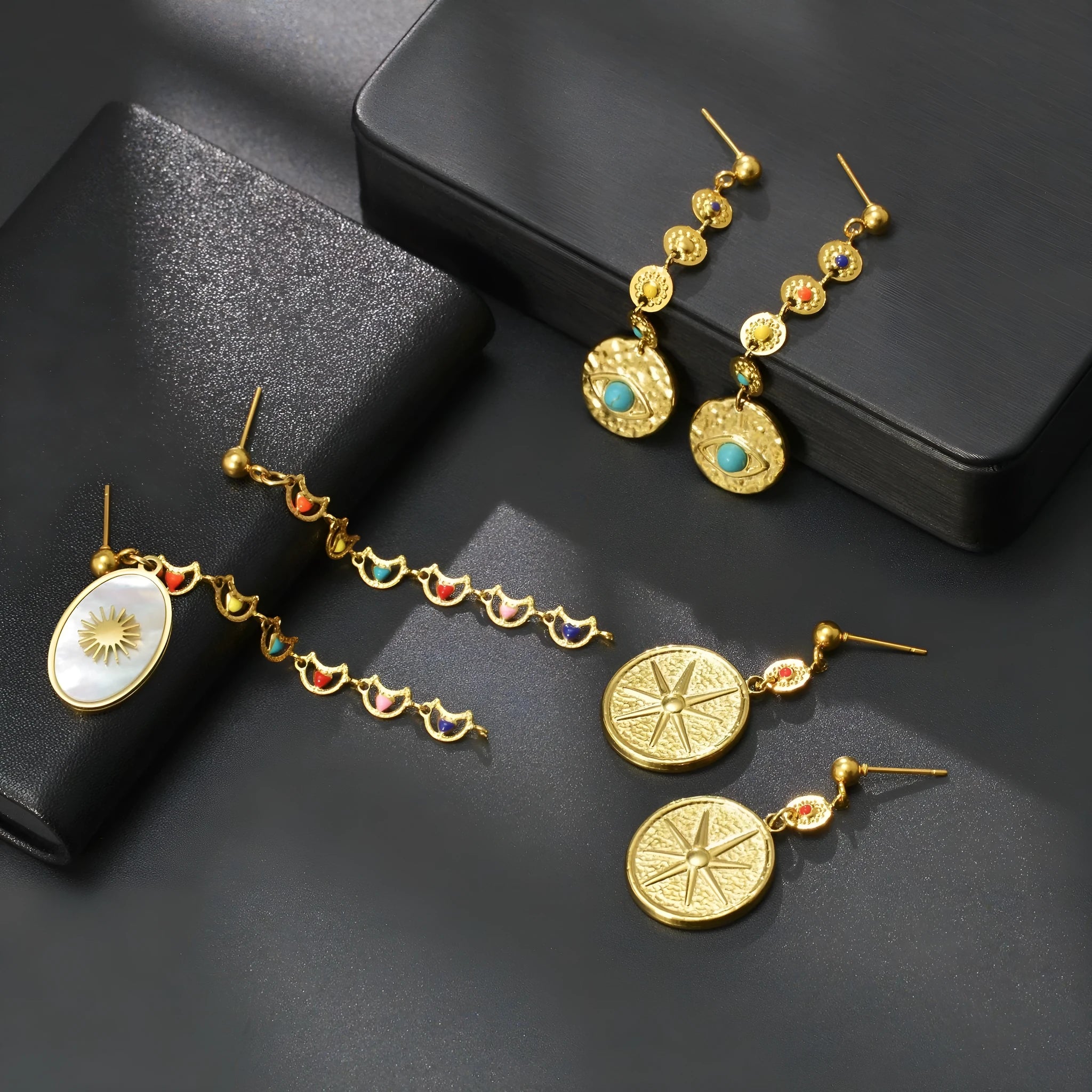 Stainless steel geometric earrings showing three style options: Eight Awn Star, Eye, and Shell Sun designs