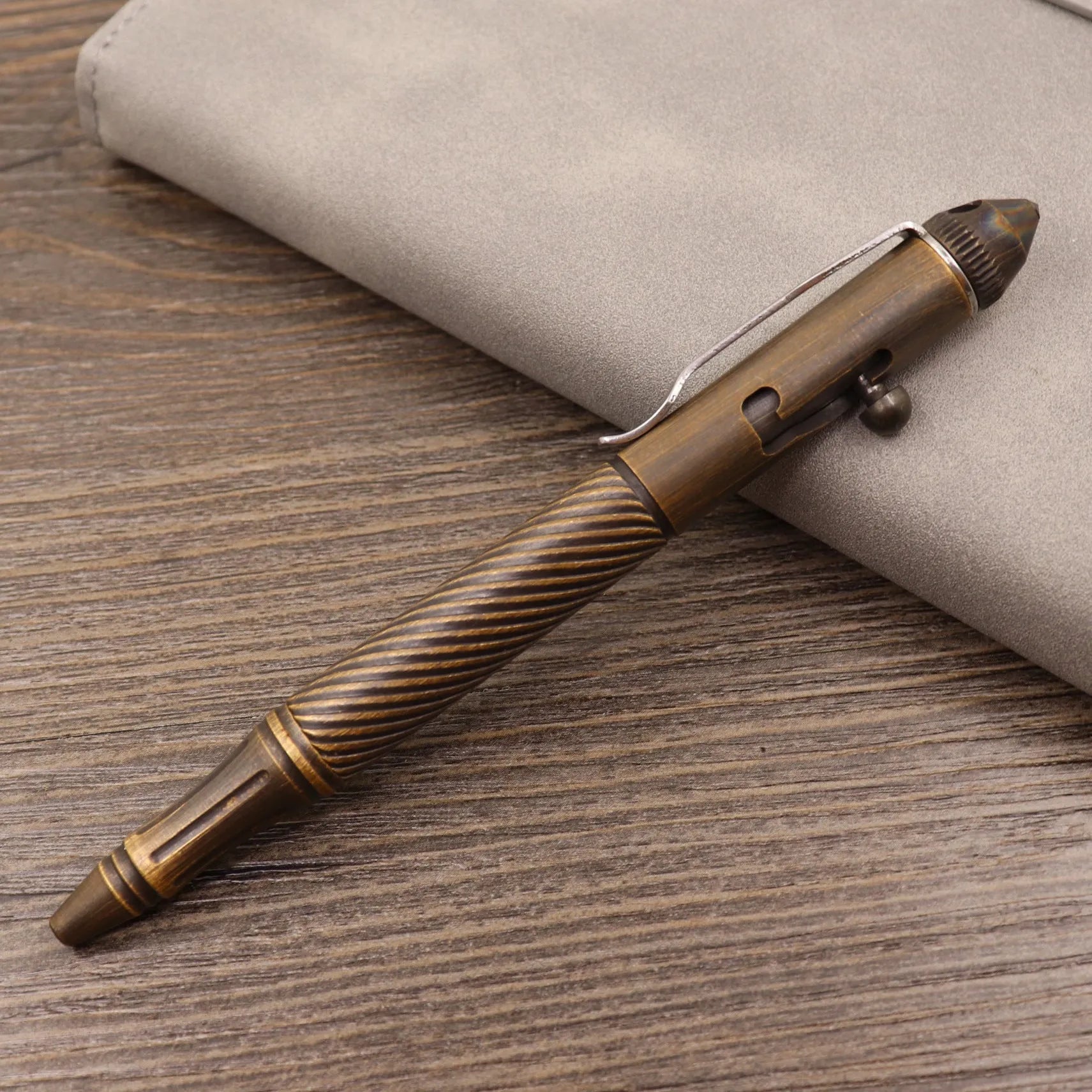 Solid brass bolt-action tactical pen showing its retro design and metallic finish.
