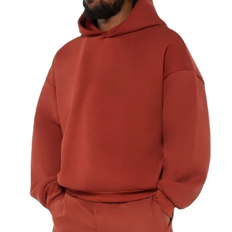A grey men's fleece-lined cotton hoodie sweatshirt with a hood and long sleeves.