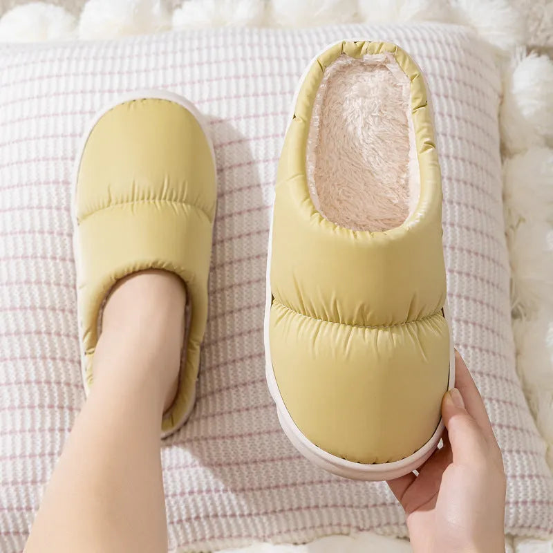 A pair of down cotton slippers with an artificial leather upper and thick rubber sole, shown in blue.