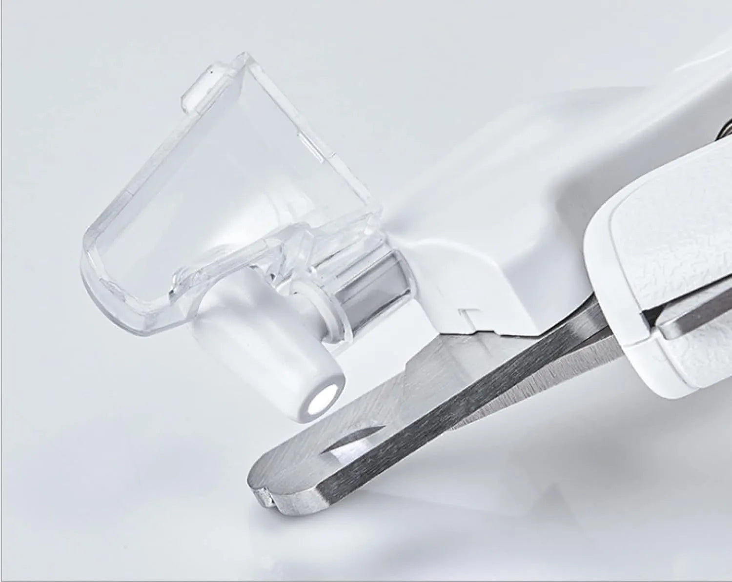 White LED pet nail clipper with a transparent anti-splash guard and a nail file on a white background.