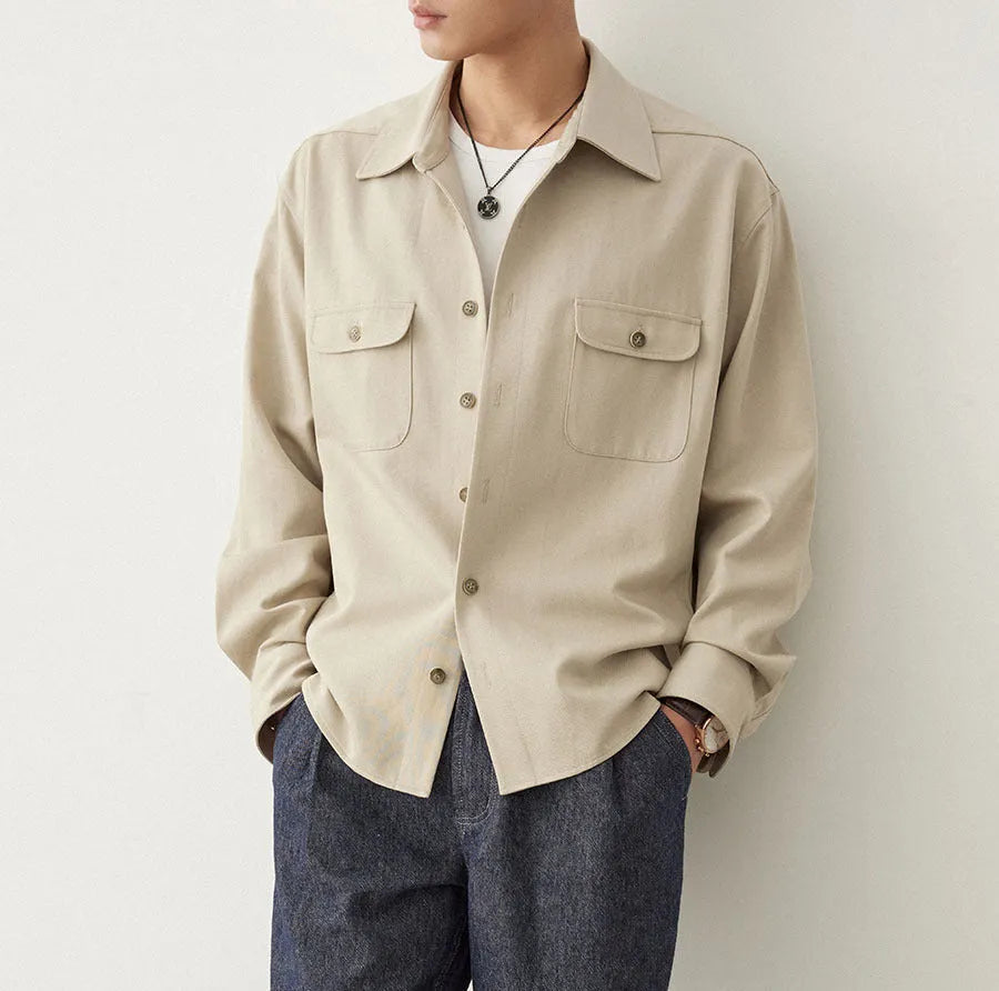 Men's light sand rice coloured lapel collar long sleeve casual shirt on a hanger.