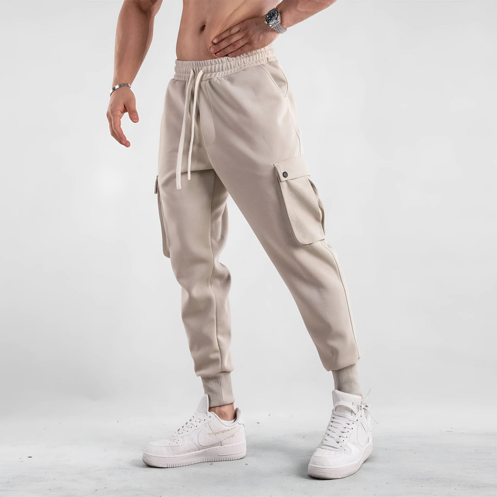 Men's loose ankle-tied cotton sports trousers in multi-pocket design showing apricot colour option