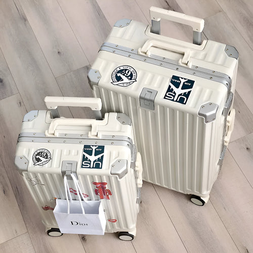 Hard-shell aluminium frame suitcase in avocado green with USB port and universal wheels.