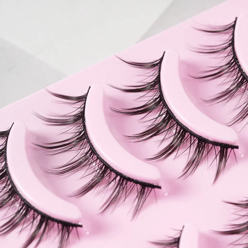 Pack of 15 pairs of natural wispy manga false eyelashes on black plastic bands for cosplay.