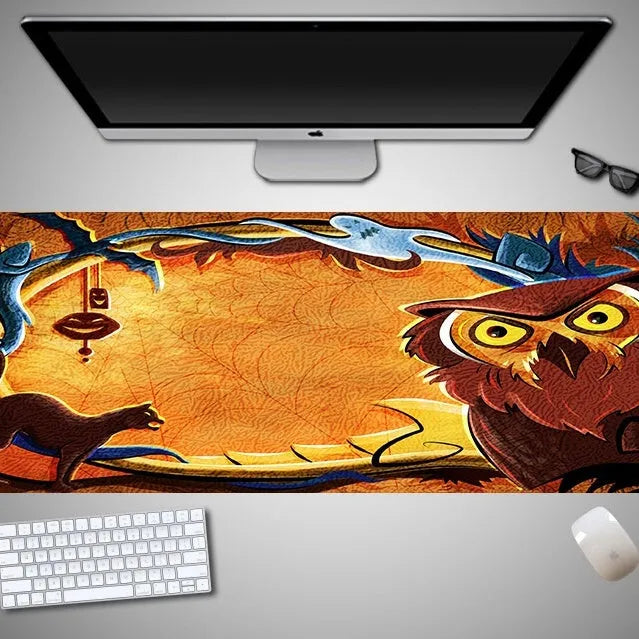 Oversized Halloween-themed rubber cloth mouse pad with non-slip base on a desk.