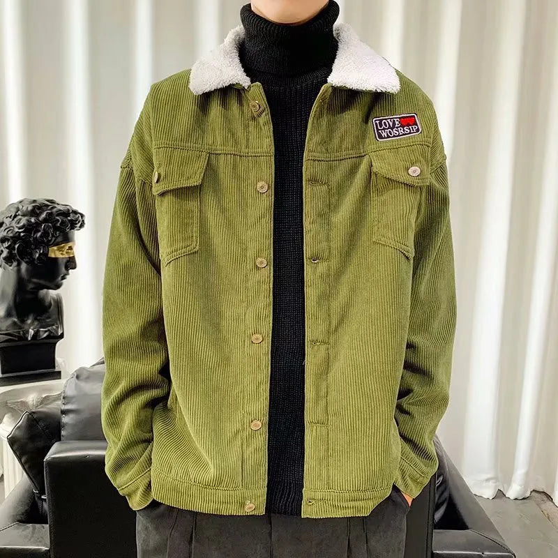 Man wearing a khaki coloured loose fit corduroy work jacket with stick pockets.