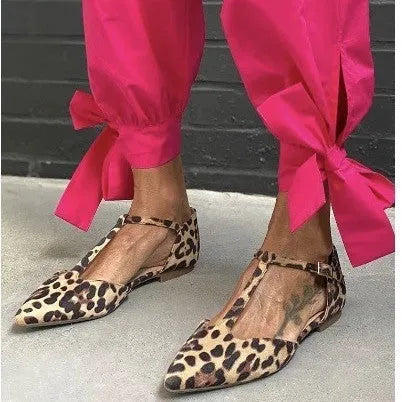 Leopard print women's pumps with pointed toe and chunky low heel featuring cross shoulder strap