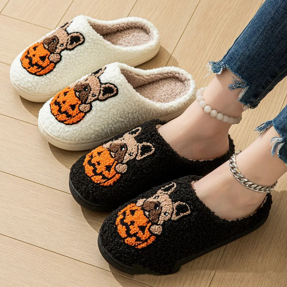Black and white Halloween slippers with pumpkin pattern, plush upper, and textured rubber sole