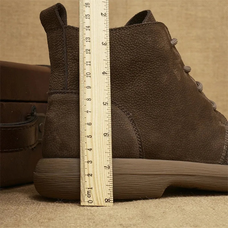 Grey genuine leather Martin boots with wedge heel and front lace-up design on a neutral background.