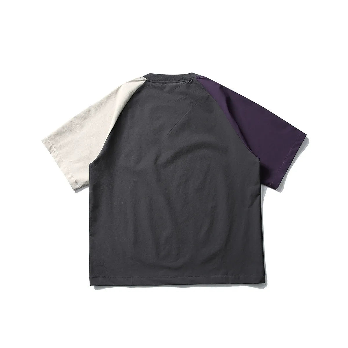 Dark grey loose fit T-shirt with contrast colour raglan sleeves on a hanger.
