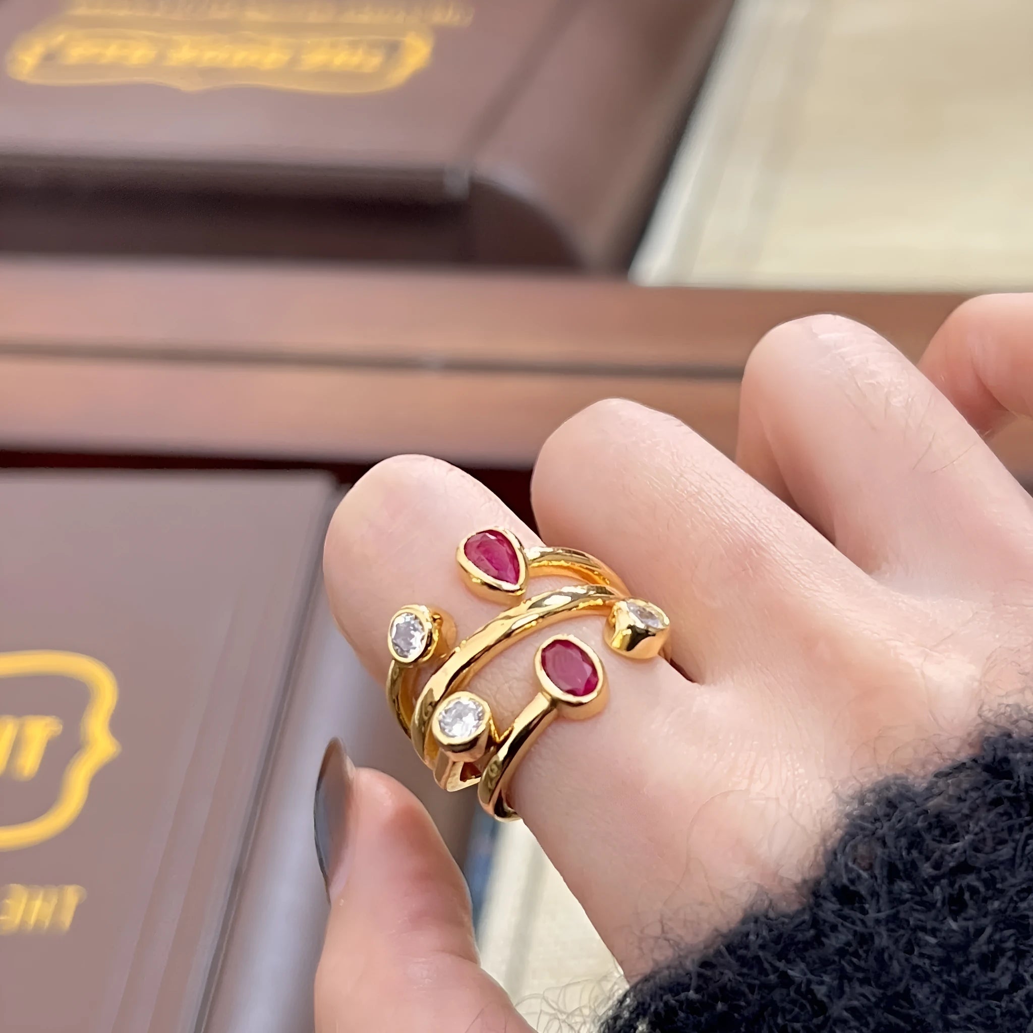 Double-headed irregular geometric cross ring in two-tone colours on a copper band.