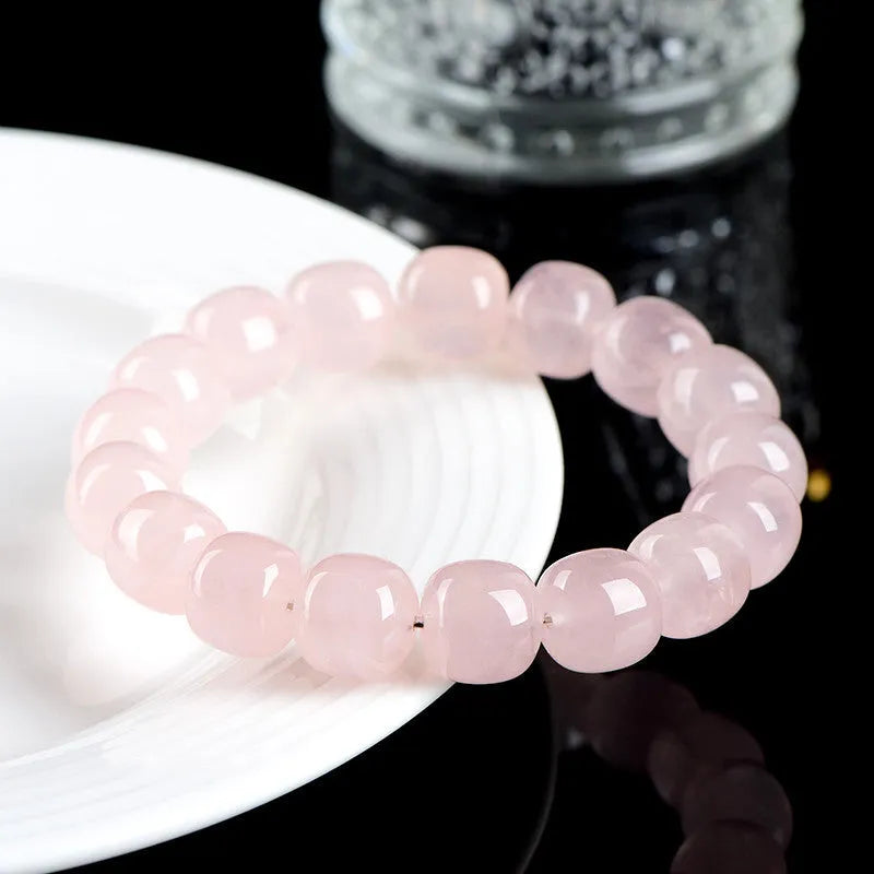 Pink crystal barrel bead bracelet with bamboo accents and geometric design