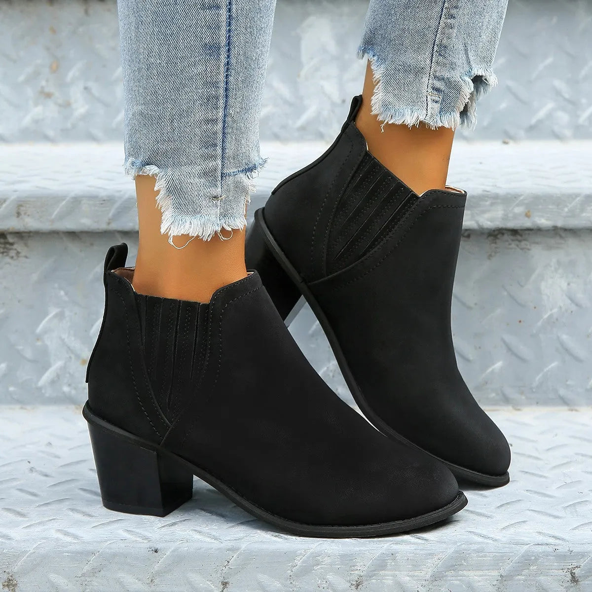 Women's black pointed toe ankle boots with thick square heel and slip-on design