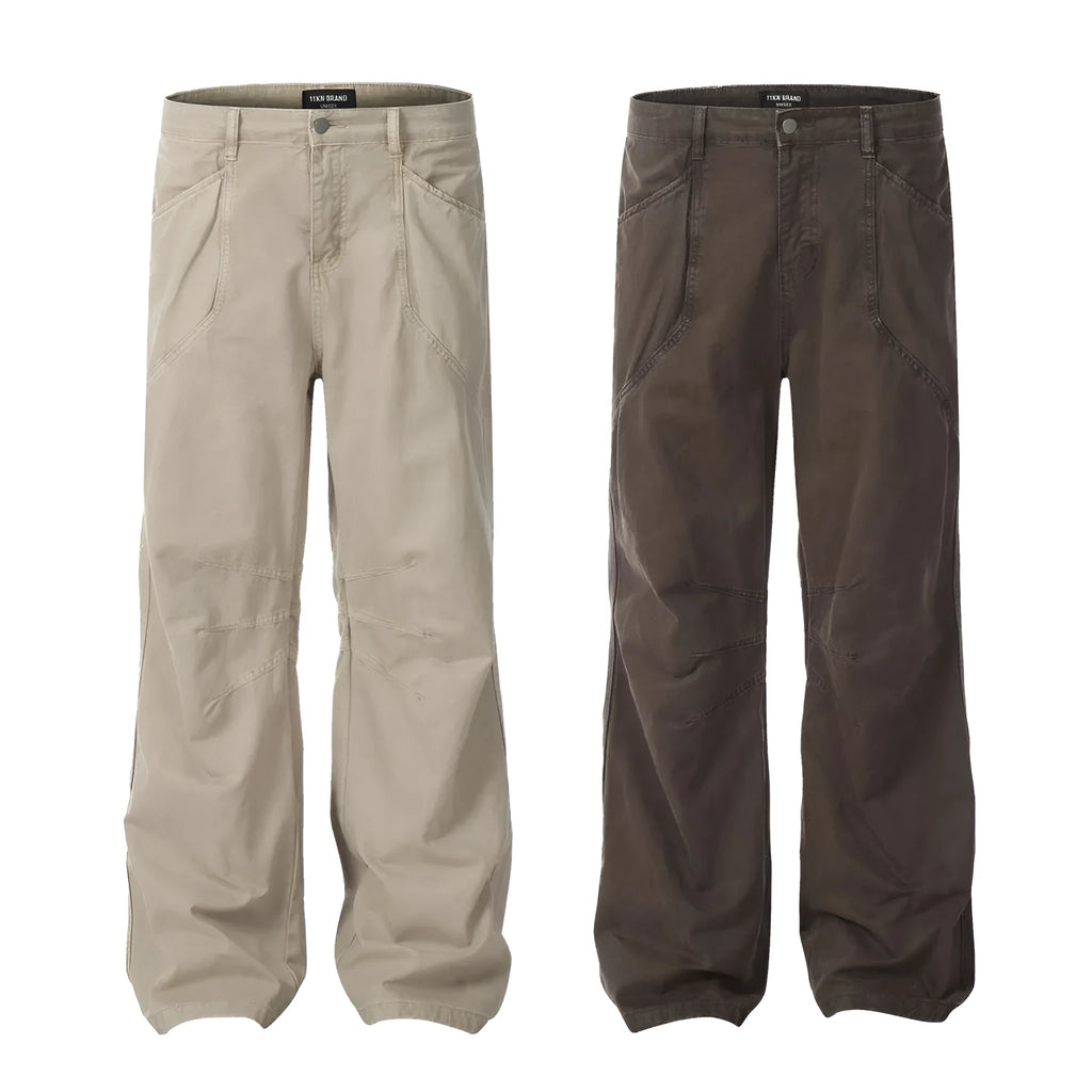 Men's brown loose fit straight leg cotton jeans with a high waist and zip fly on a hanger.