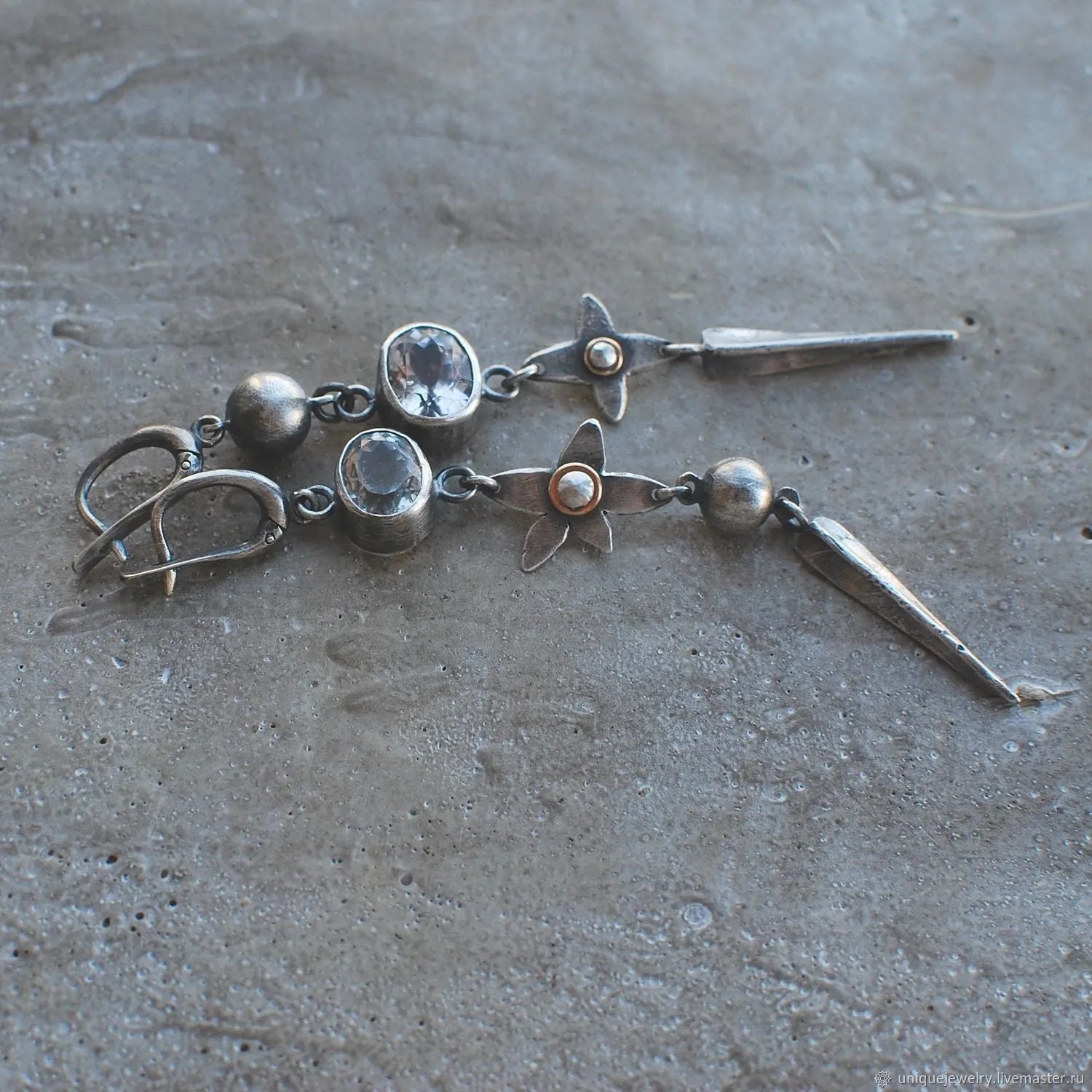 Geometric long pendant earrings with antique silver plating and rhinestone details on an XINGX design.