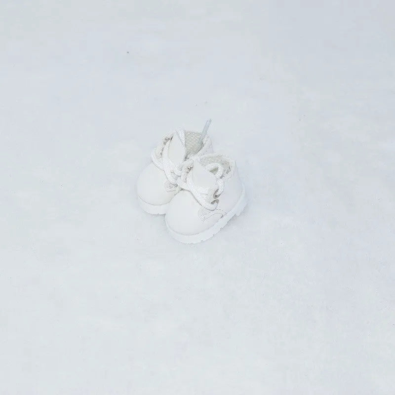 A pair of 17cm high PU replacement shoes for dolls in a selected style and colour.