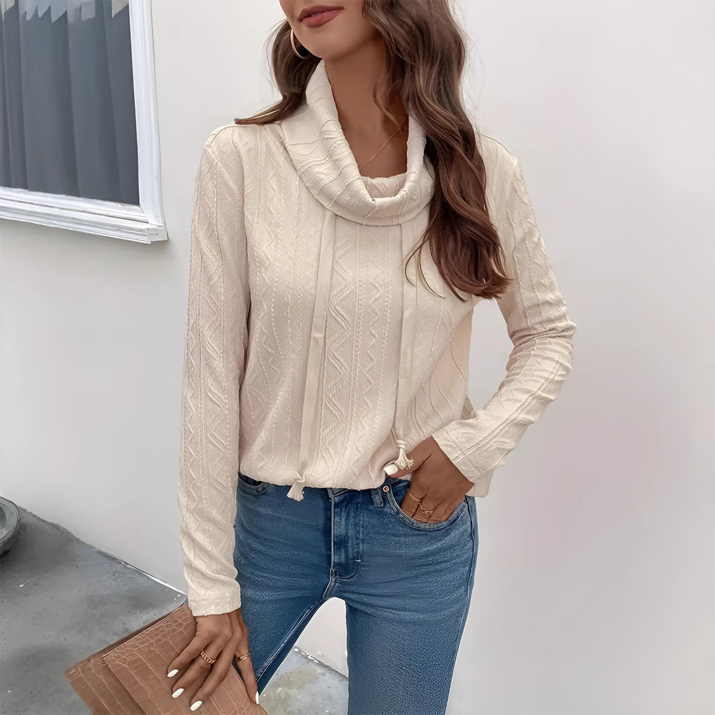 Apricot coloured long sleeve hooded pullover sweater with a drawstring hood on a hanger.