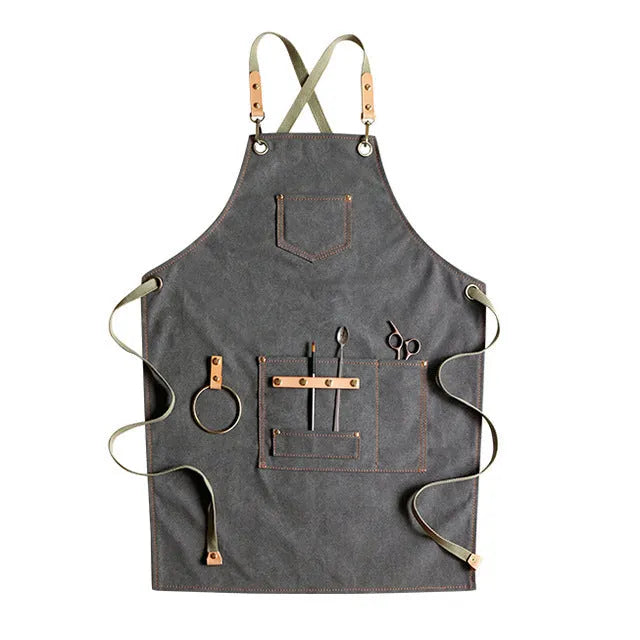 Canvas cross-back apron in camel colour on a mannequin, showing adjustable neck and waist ties