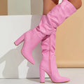 White women's long pointed high-heel boots with a side zip on a white background.