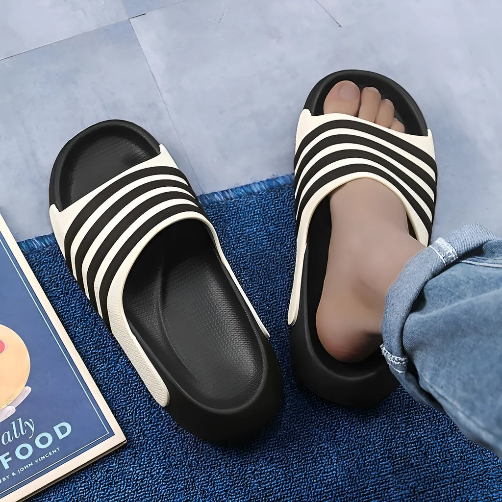 A pair of casual leisure sports style slippers with a PVC upper and EVA sole, shown in beige colour.