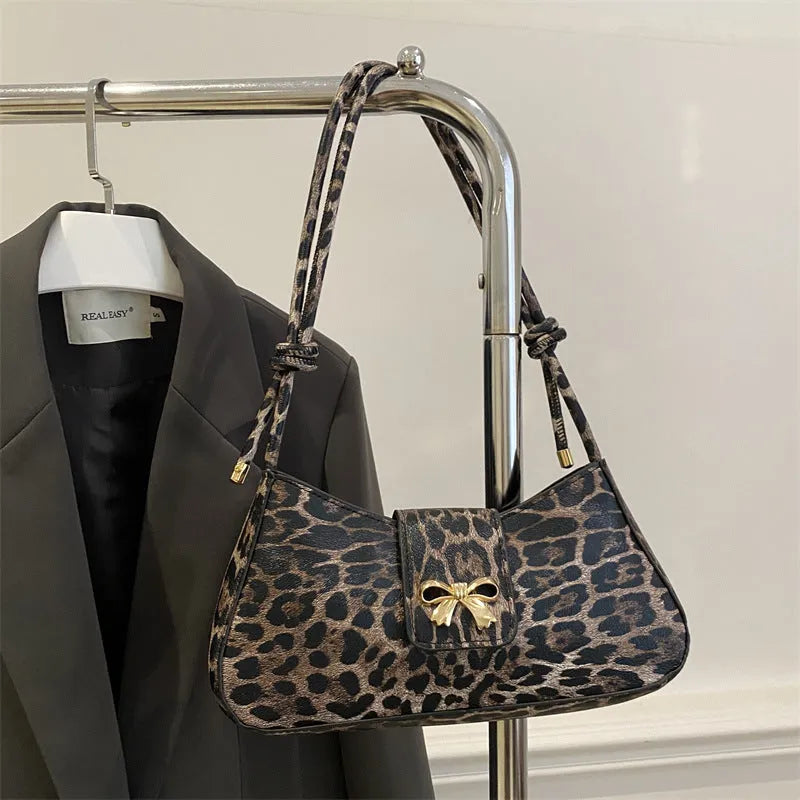 Casual women's PU handbag with sandwich pocket organisation in black colour showing 27 cm width