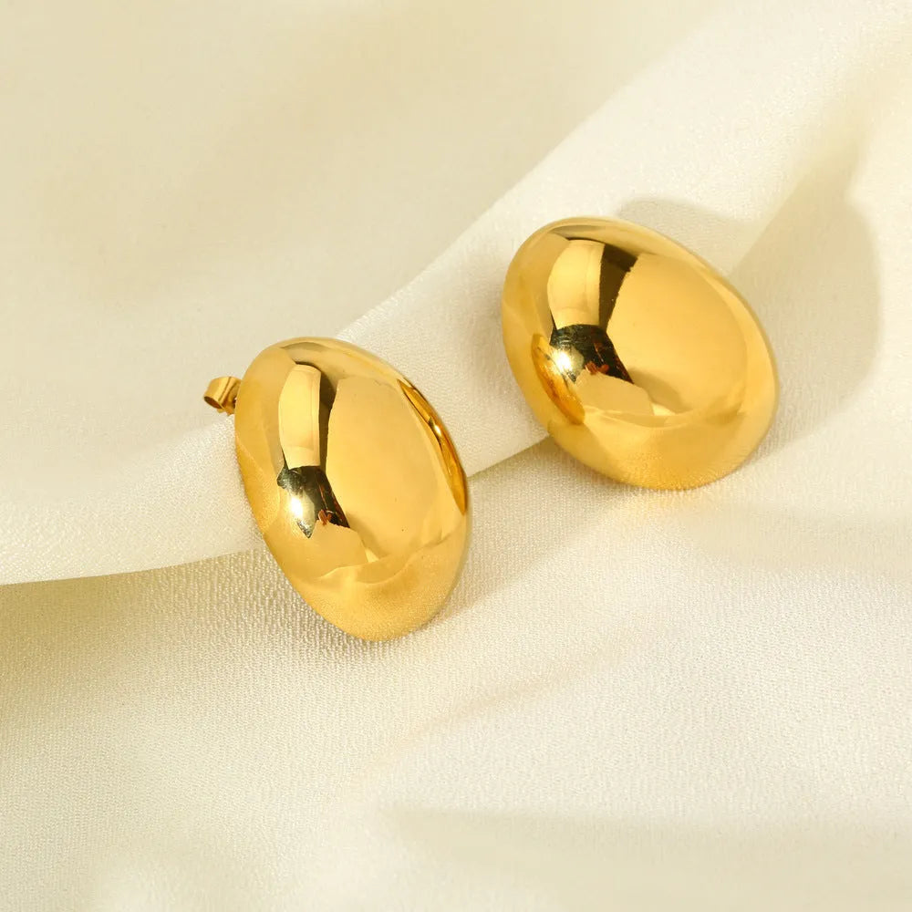 A pair of geometric stainless steel ear studs with a linear design and a glazed gold-coloured surface.