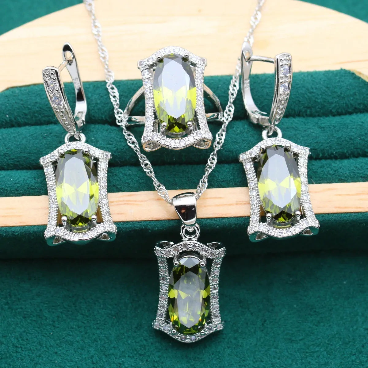 Anti-allergy zircon jewellery suit showing necklace, earrings, ring, and bracelet in olive colour with snake bones chain.