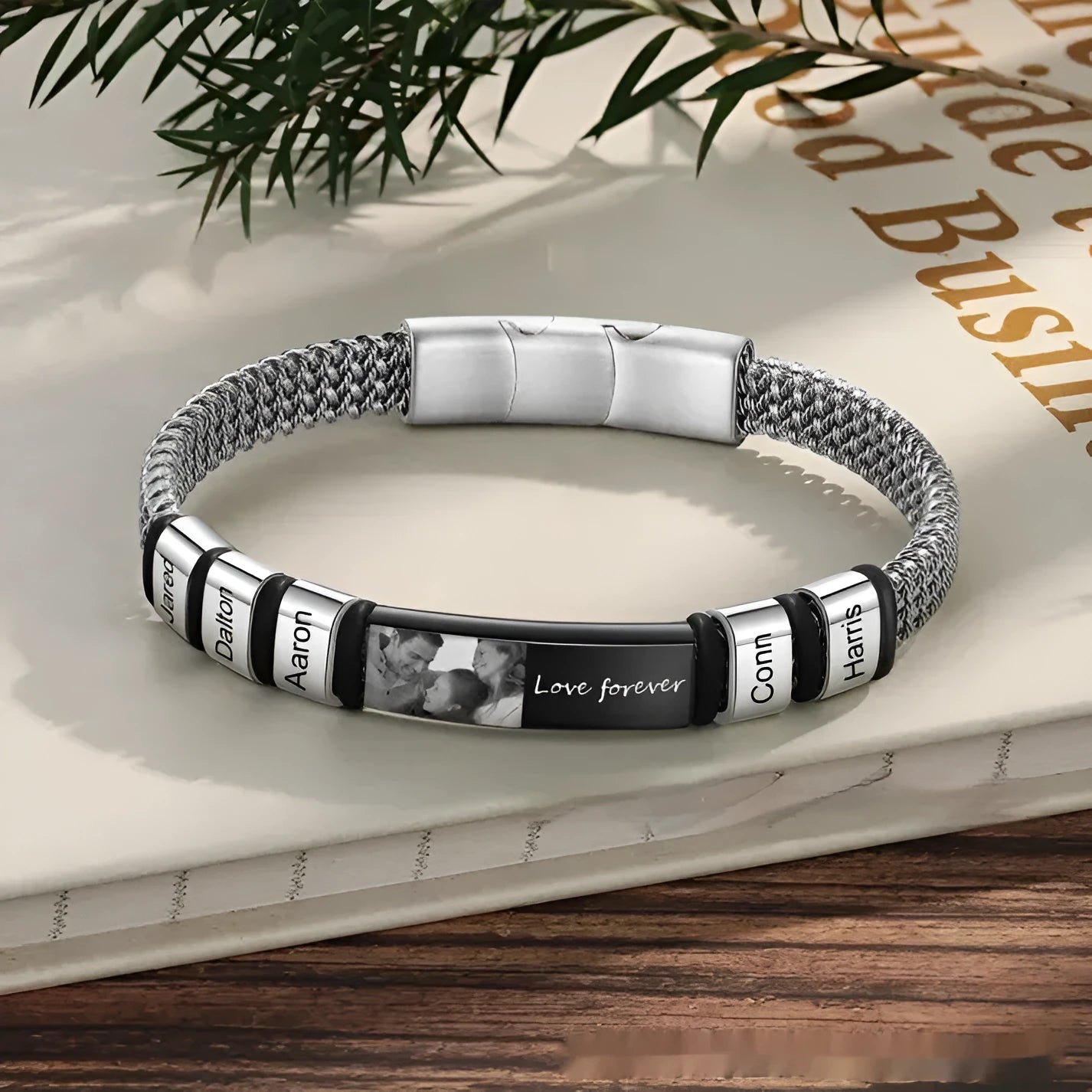 Men's titanium steel lettering bracelet with leather rope strap and heart charm, showing engraved bead options.