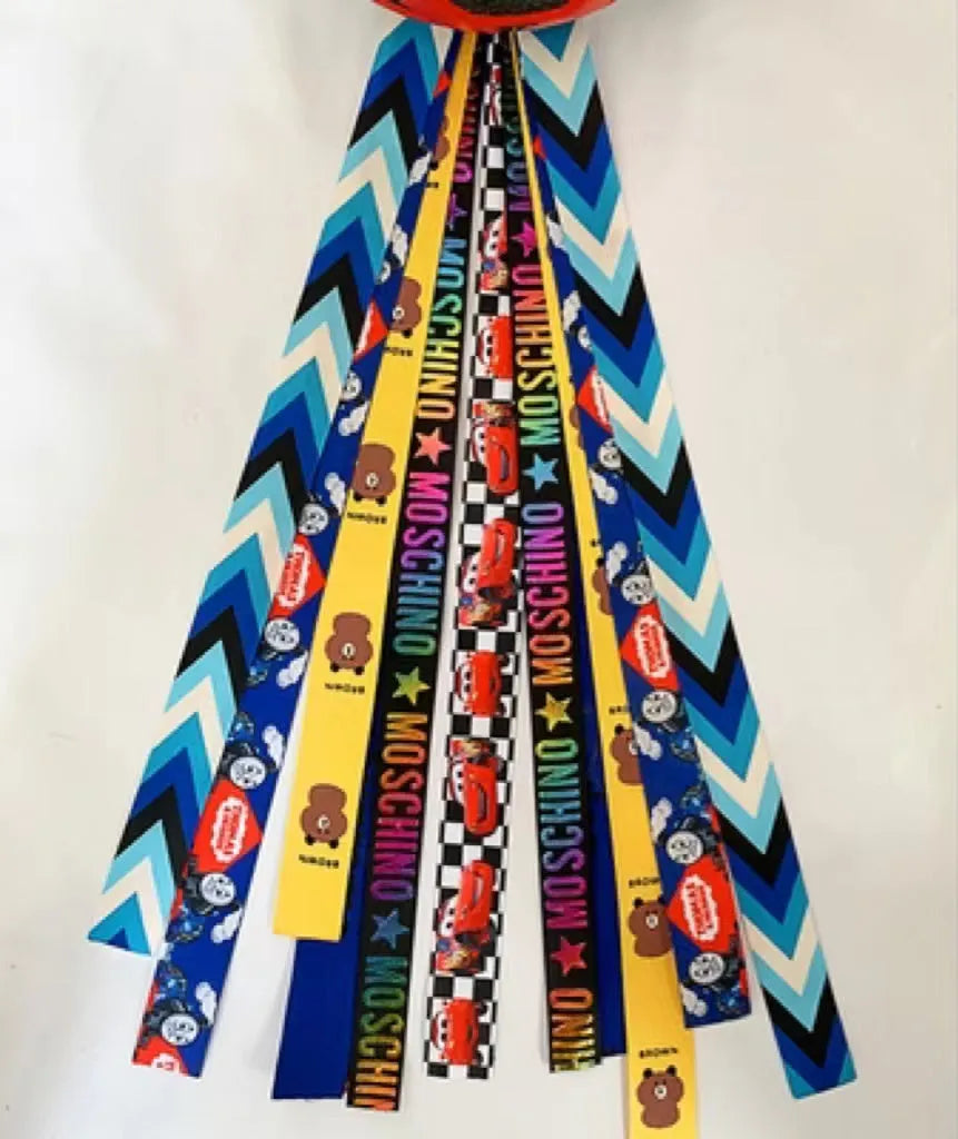 Decorative ribbon streamer for a child's ski or skating helmet in various colour options.