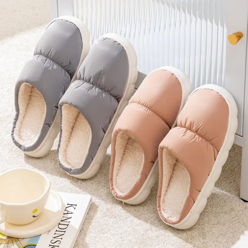 A pair of down cotton slippers with an artificial leather upper and thick rubber sole, shown in blue.