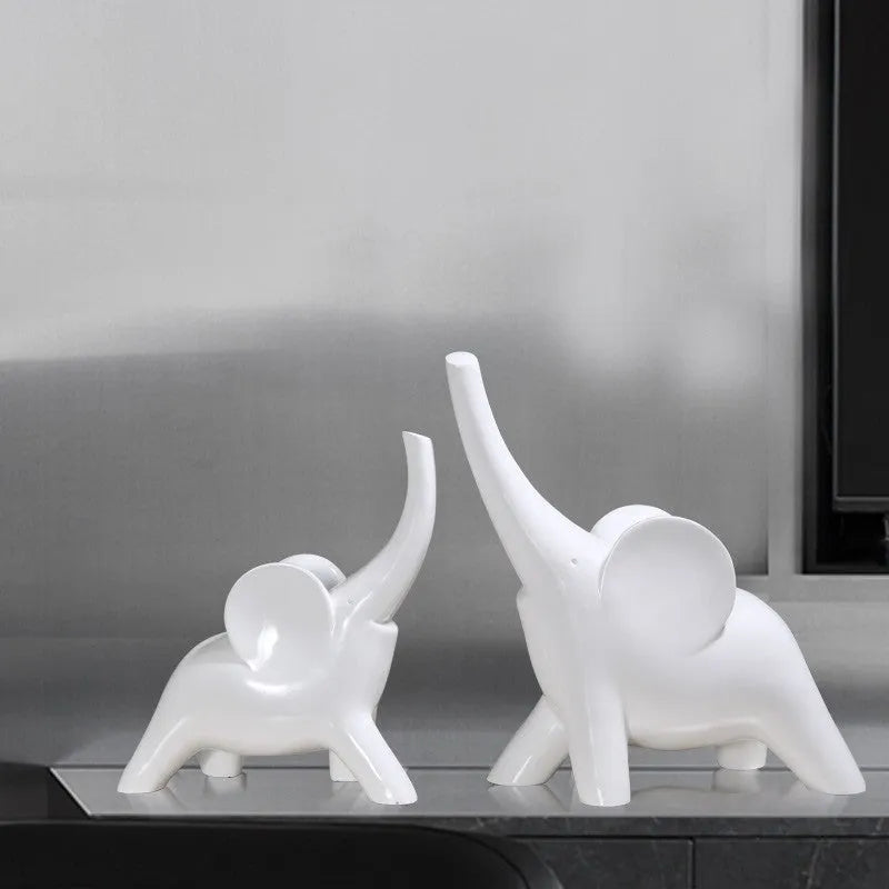Rose gold and white resin elephant ornaments in large and small sizes displayed singly and as pairs