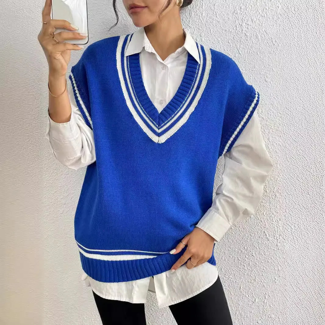 Women's loose fit college style wool vest sweater in blue, laid flat.