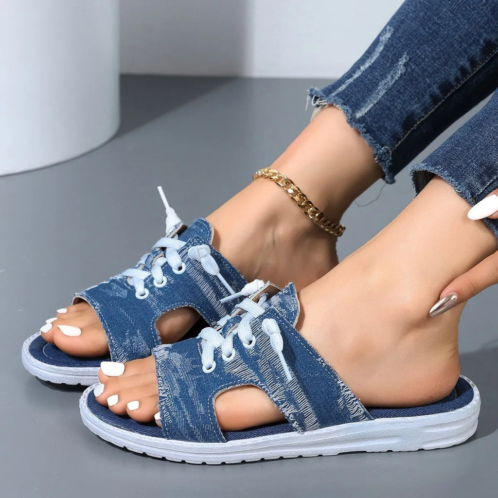 Blue Roman style canvas slippers with cloth upper and rubber sole displayed in adult sizes