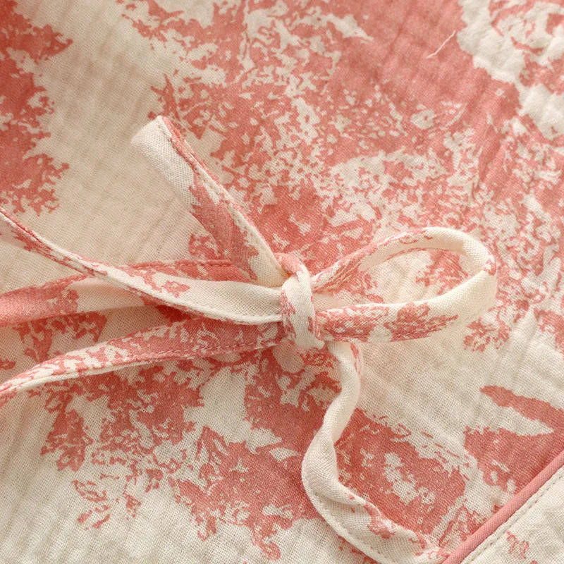 Women's pink cotton gauze lounge suit two-piece set with lace-up front trousers detail.