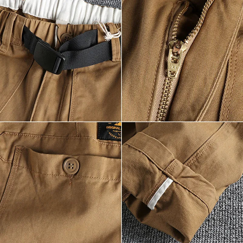 Men's khaki cotton work trousers with mid waist and zipper fly on a neutral background