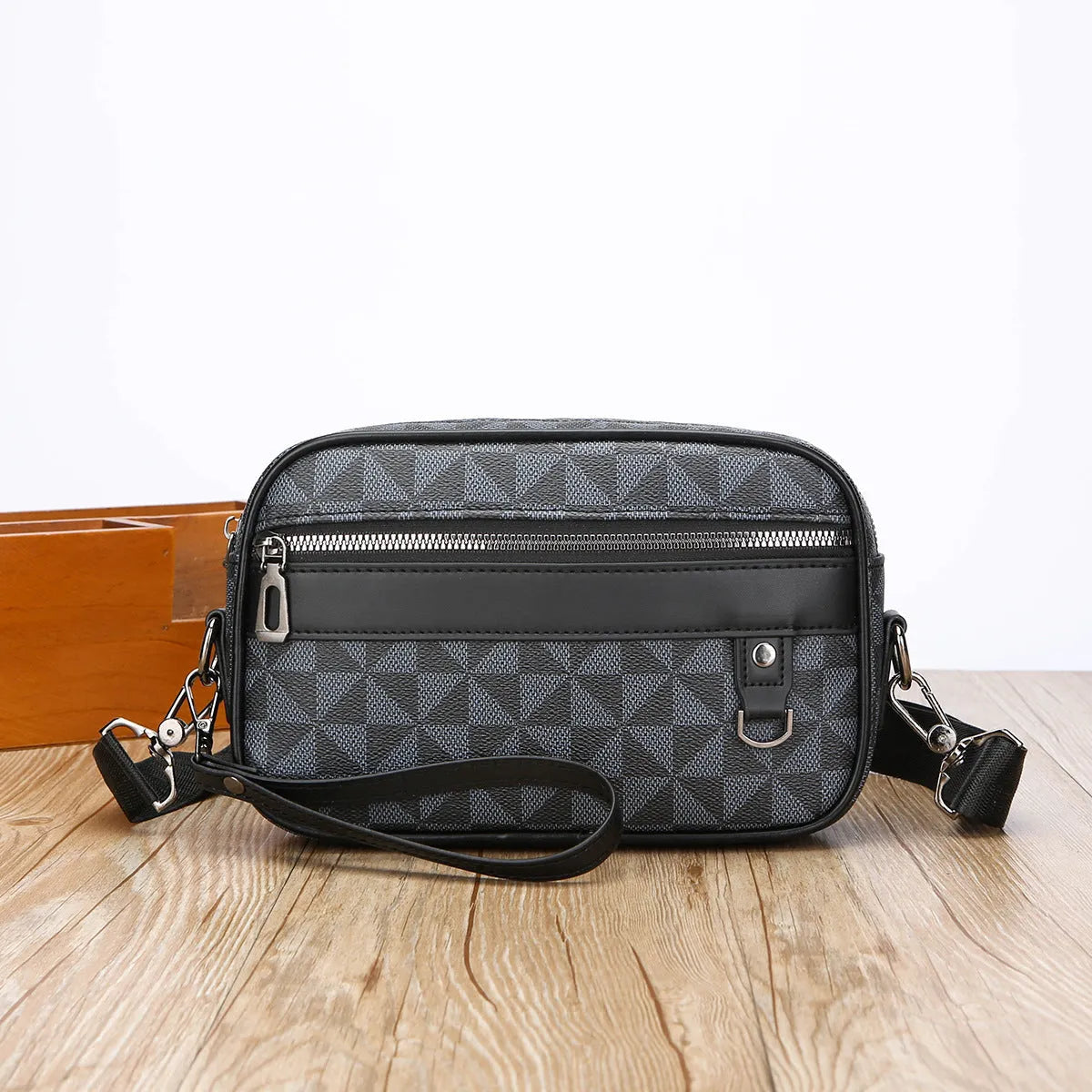 Men's black geometric pattern PU messenger bag shown horizontally with shoulder strap