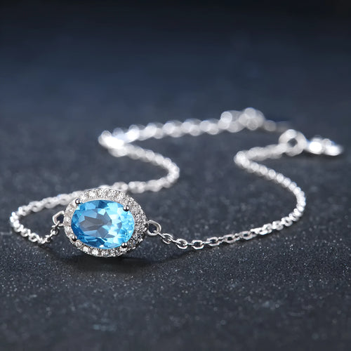 925 sterling silver jewellery set with blue topaz gems showing earrings, ring, pendant and necklace with geometric design