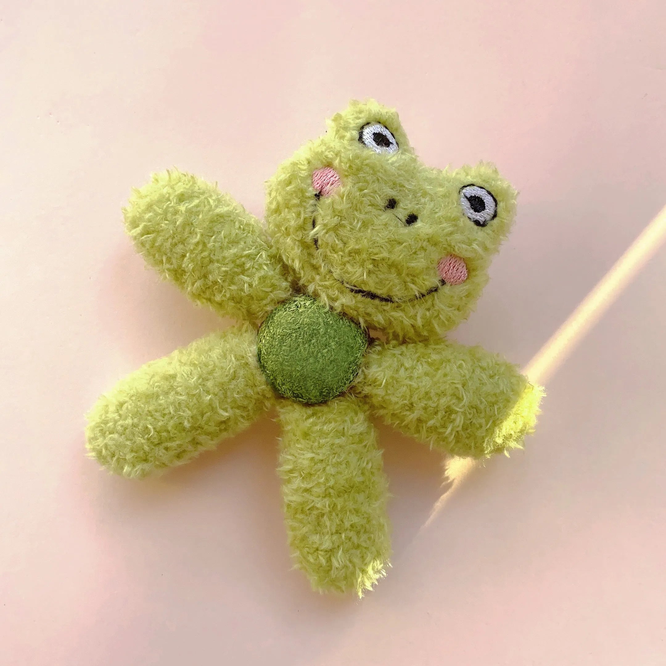 Brown bear shaped stuffed catnip ball edible chewing toy for cats on a white background.