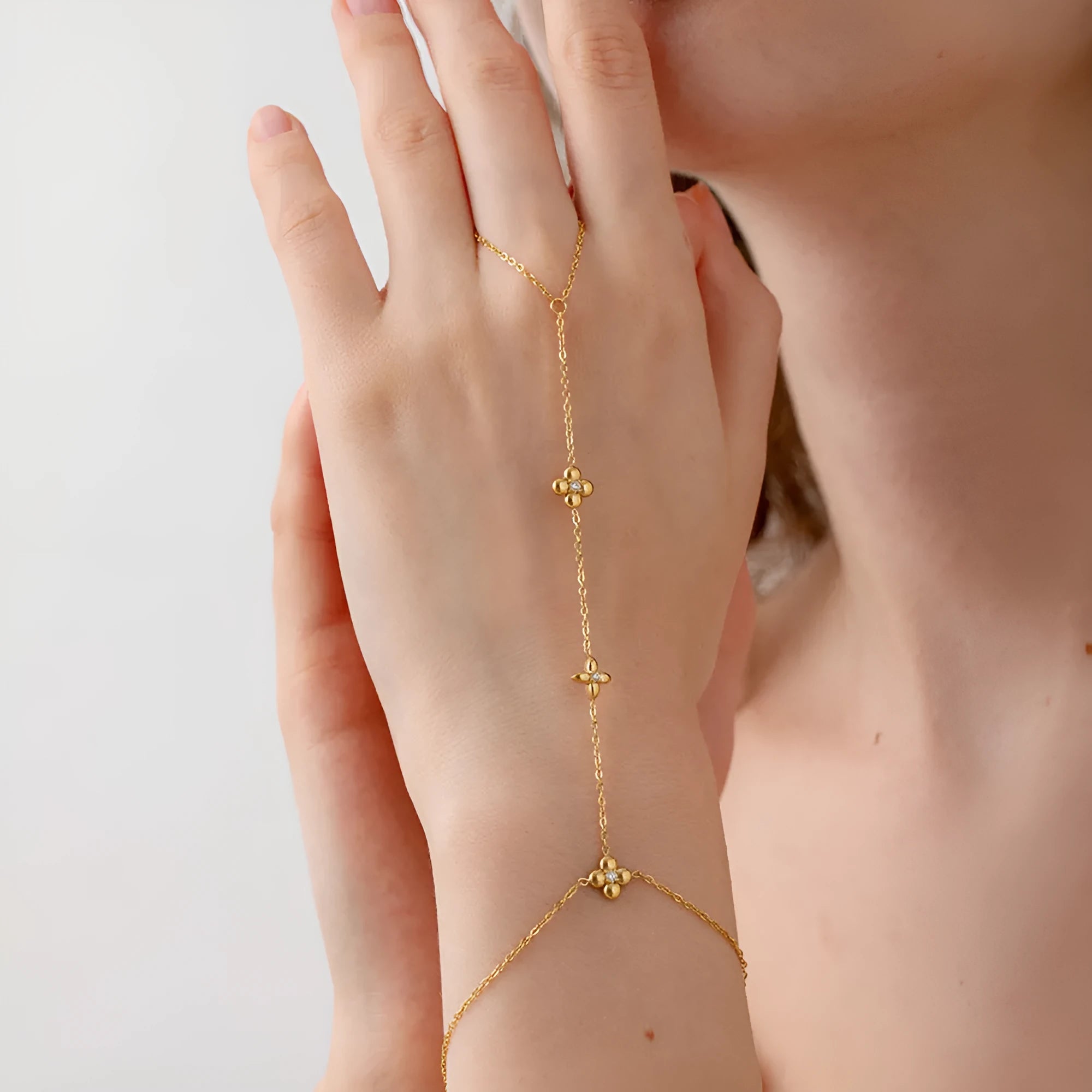 Women's gold stainless steel bracelet with geometric eight-pointed star and flower designs