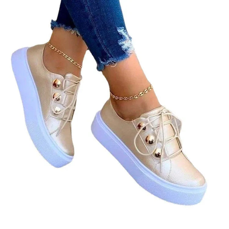 Women's white lace-up flats sneakers with rivet details and round toe design