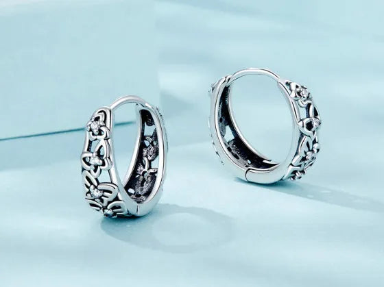 Retro hollow butterfly earrings in sterling silver with zircon accents, measuring 14mm by 5mm
