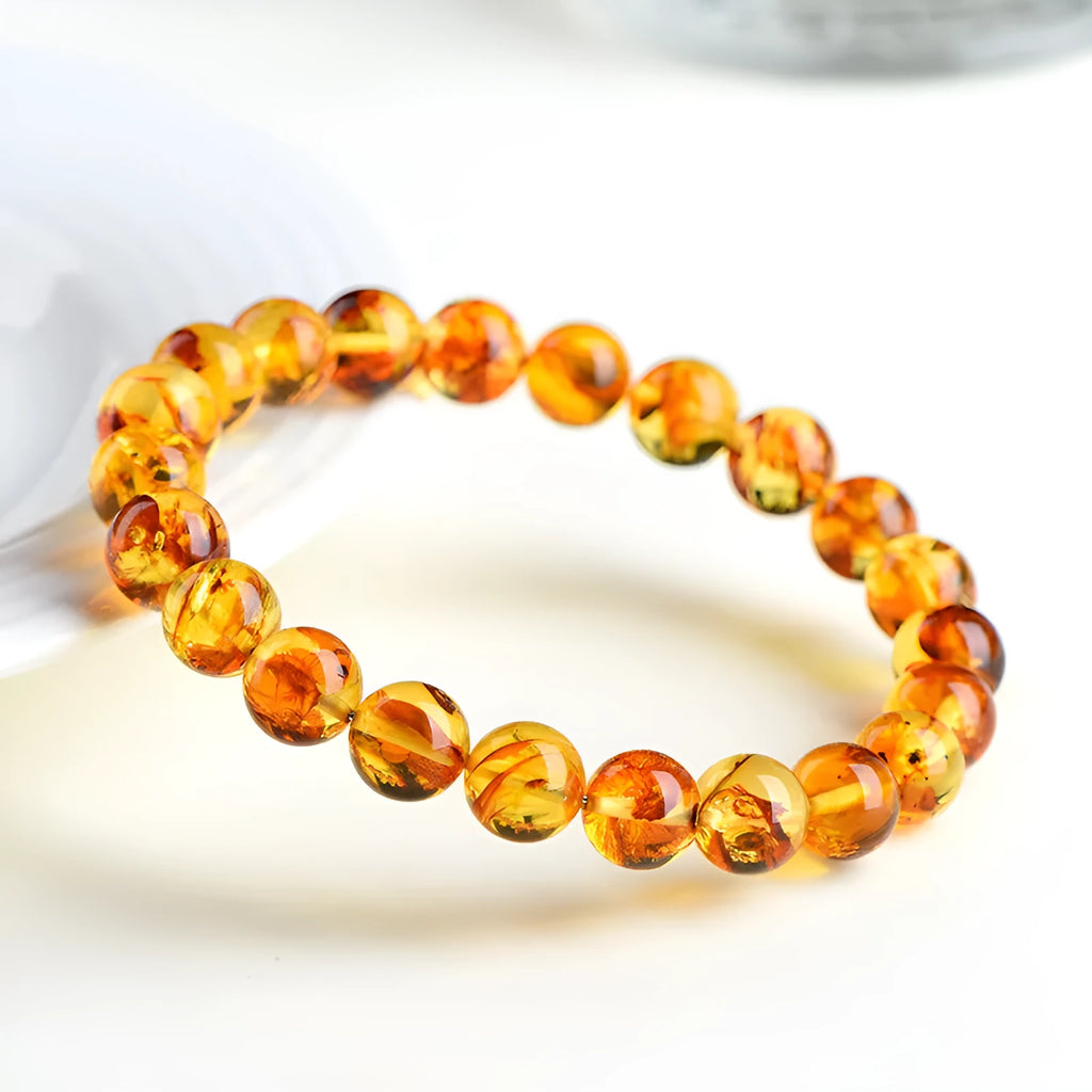 Natural yellow piebald amber bracelet with polished geometric beads on a string