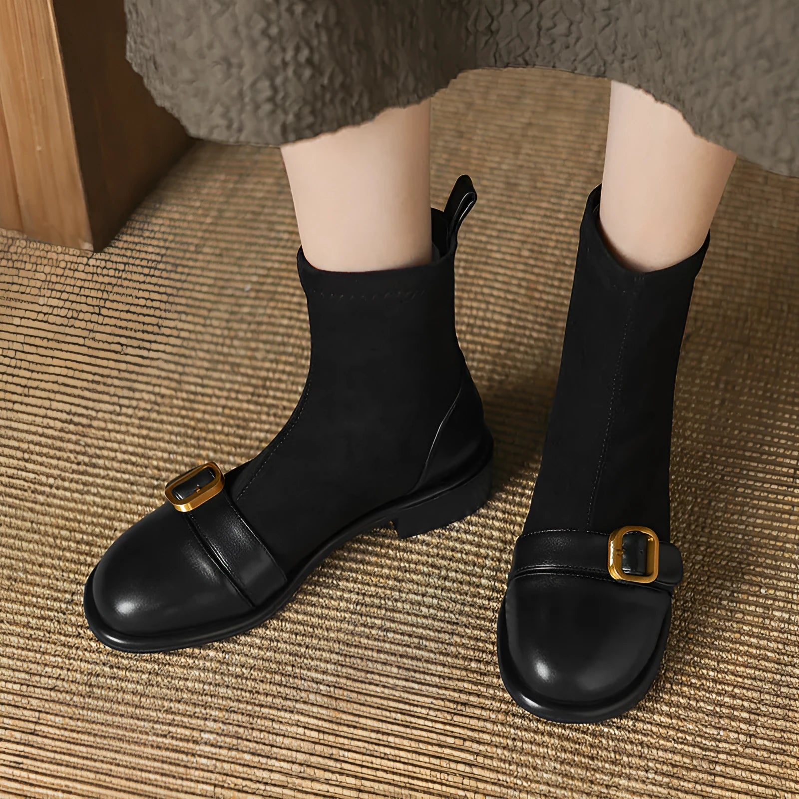 Women's black low heel Martin boots with front lace-up and belt buckle stitch detailing on a white background.