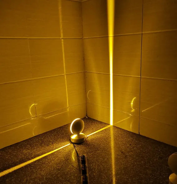 Modern aluminium and glass LED spotlight bar wall lamp mounted on a wall.