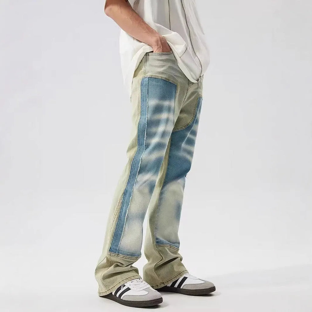 Retro yellow and blue patchwork jeans with splash-ink distressing, mid-waist cut with zip fly