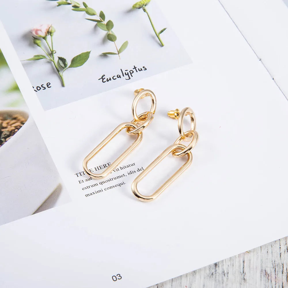 Sterling silver geometric hoop earrings with needle posts and ring-line design